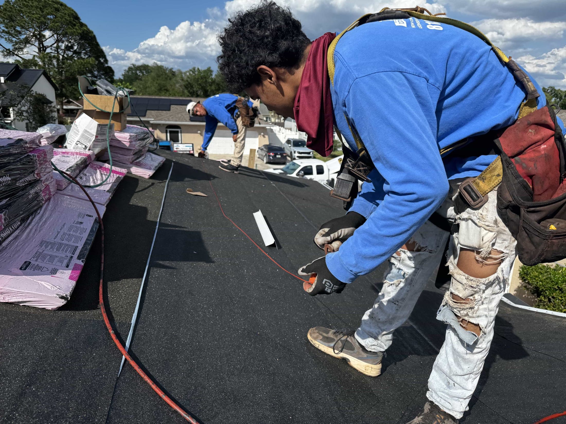 Installer securing underlayment and flashing details