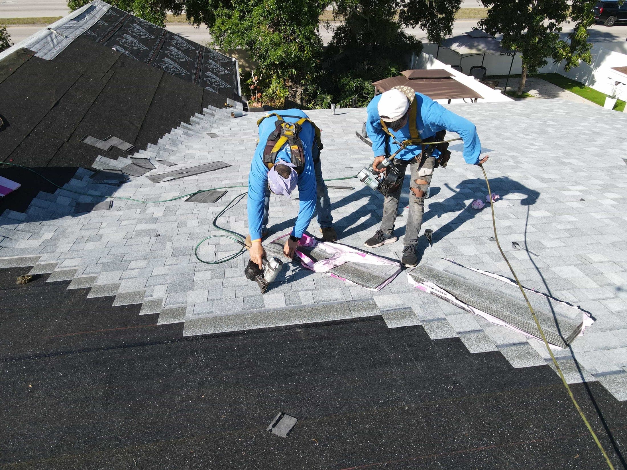 Installer securing shingles with a tool belt