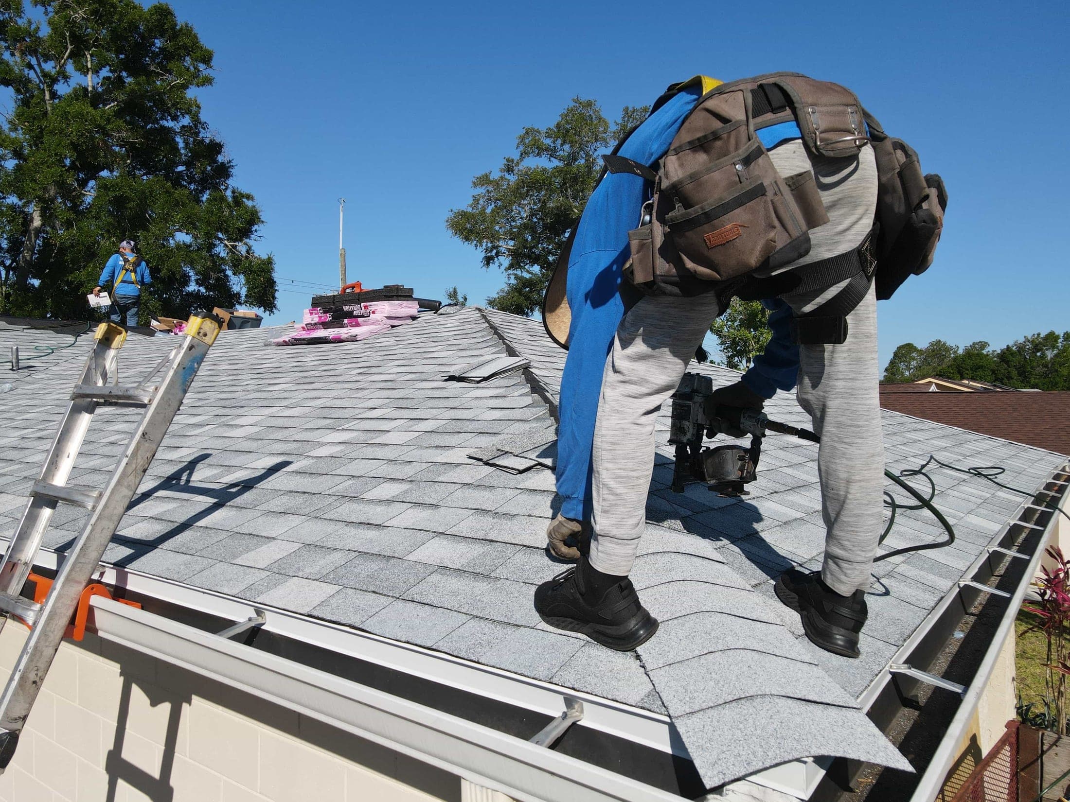 Roofer walking a finished shingle roof