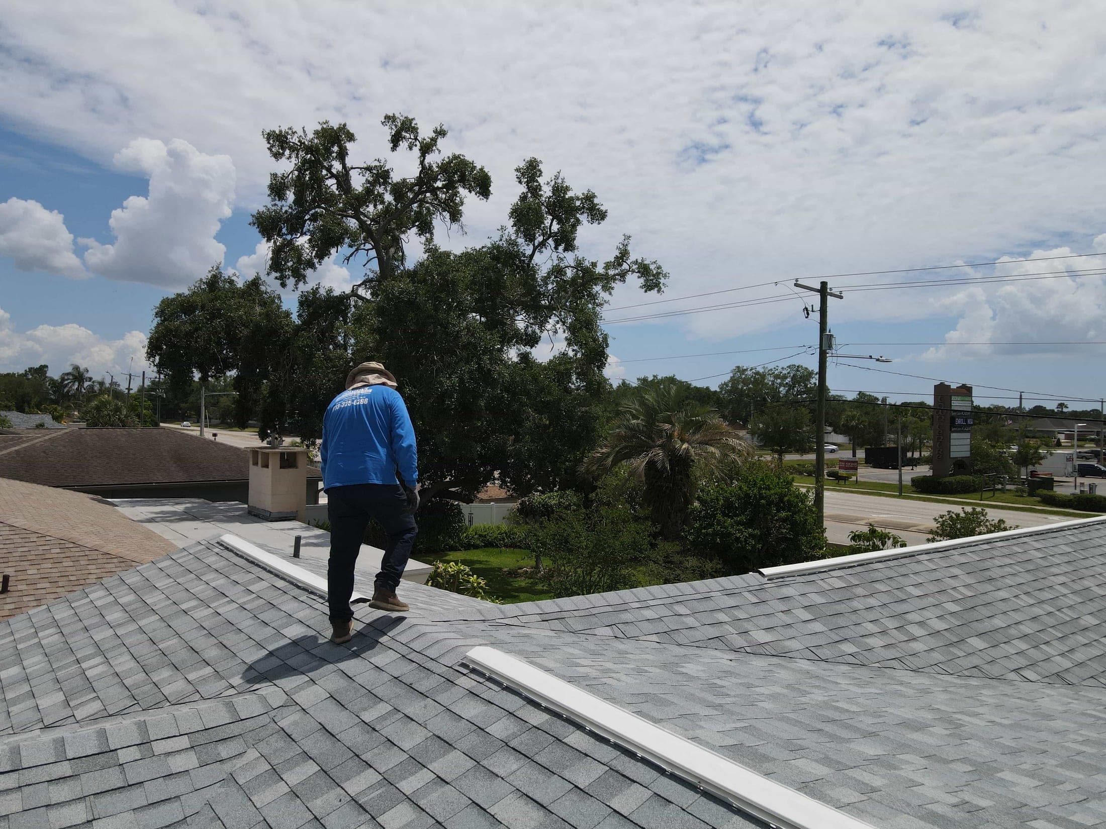 Roofer inspecting a completed roof